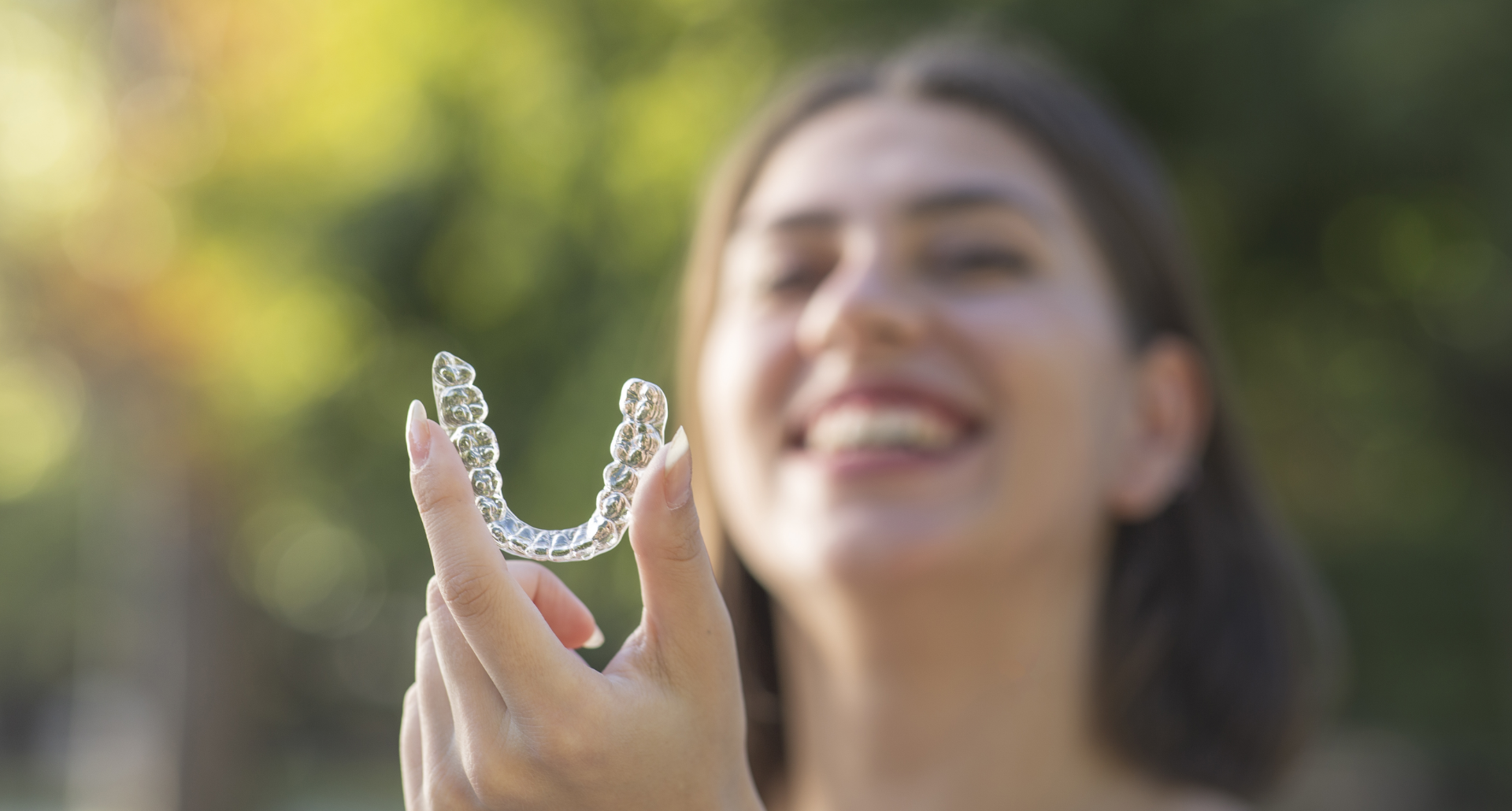 woman with an Invisalign aligner 