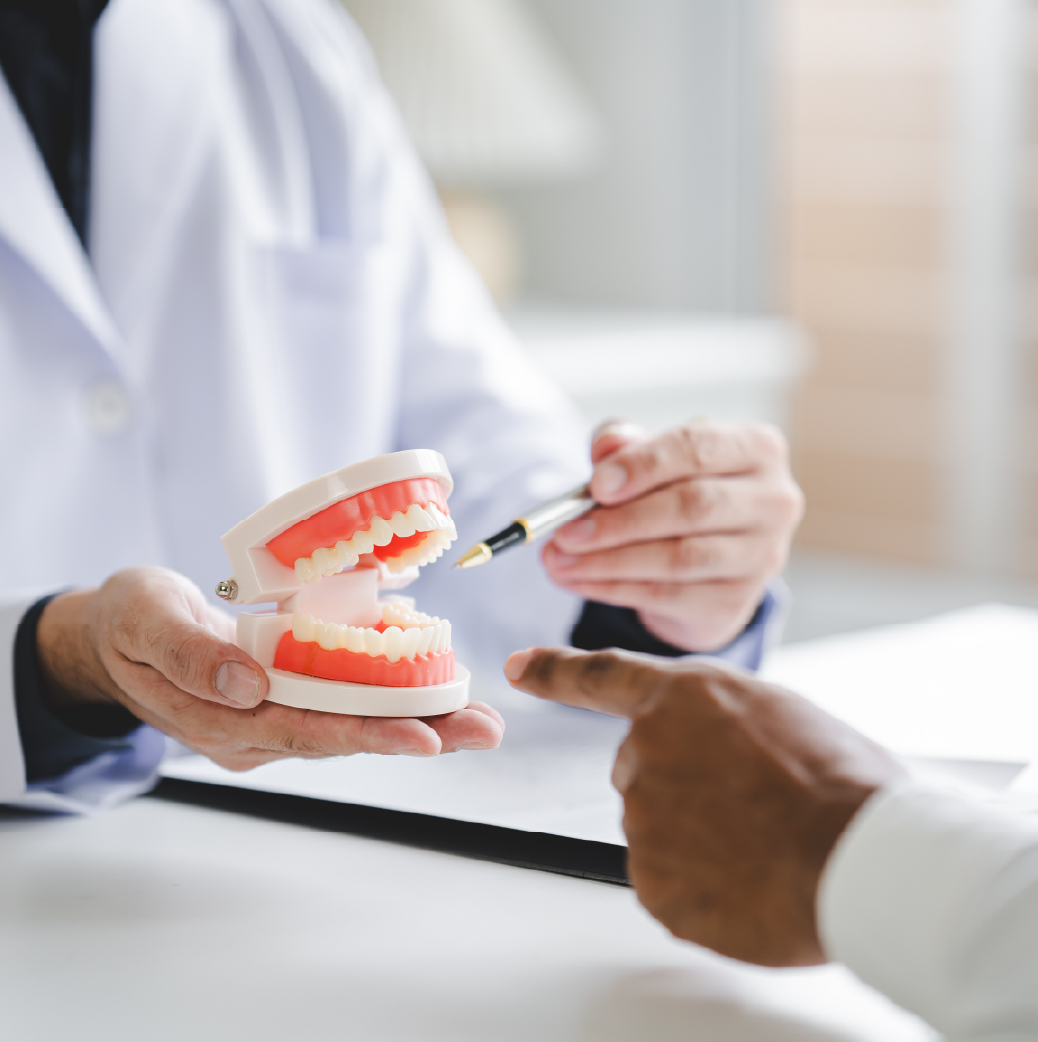 dentist educating a patient on what a root canal is 